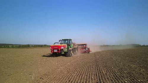 Tractor on the field seeding wheat