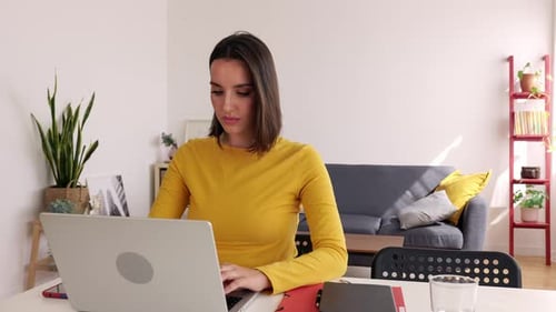 Young Woman Working on Laptop at Home