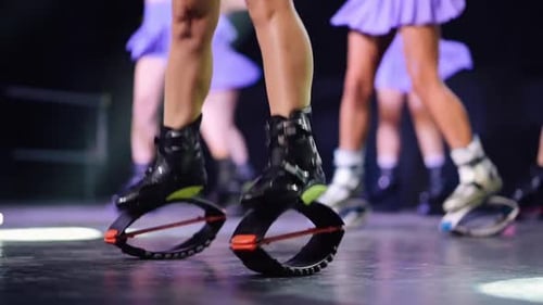 Close-up of Women Doing Exercises with Rebound Boots. Sports, Fitness, Jumpers