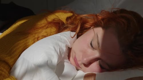 Woman Sleeping Peacefully in Bed Sunlight