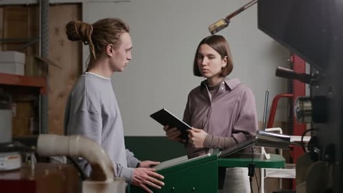 Female Manager Explaining Working Tasks to Technician at Coffee Roasting Factory