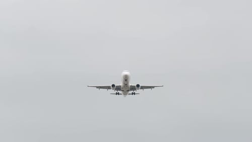 Front View Passenger Airplane in Cloudy Sky Aircraft Overhead Bottom View Jet Plane Flies for