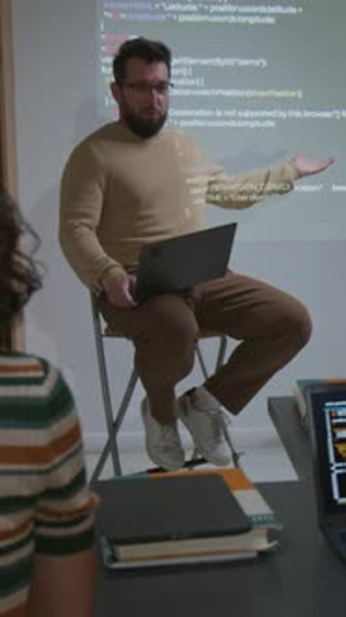 Vertical of Male IT Teacher Giving Lecture on Programming to Students