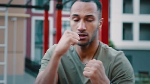 Athletic Man Practicing Boxing Techniques Outdoors