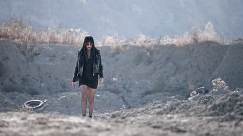 Stylish Woman Walks in Arid Desert Landscape