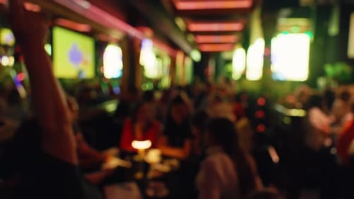 A Busy Restaurant Scene with a Blurry Background and Vibrant Lighting Enhances the Overall Ambiance