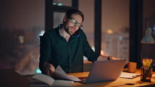 Busy Investor Talking Mobile Phone Holding Papers at Night Office Closeup