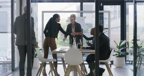 4k video footage of a group of businesspeople shaking hands during a meeting in an office