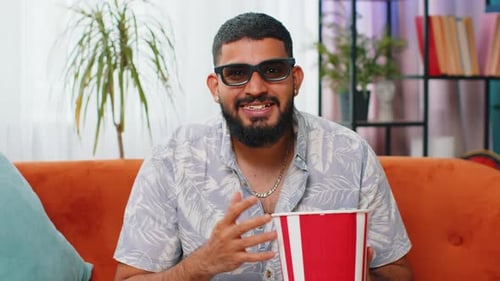 Enthusiastic Man Watching a Movie While Eating Popcorn