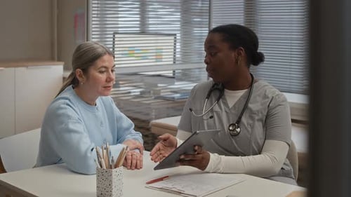 Doctor Talks to Patient in Doctor's Office