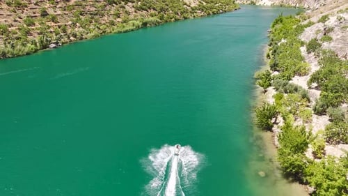 Aerial Video of Jet Skis on River Surrounded By Rock Slopes