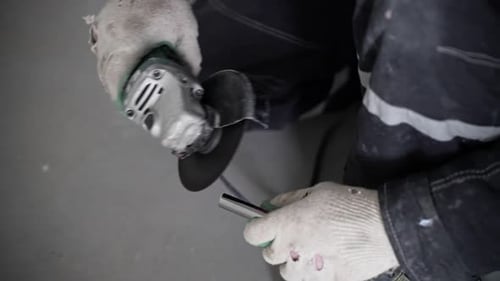 Close up of person cutting metal pipe