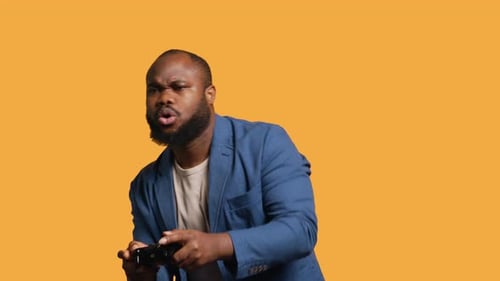 Portrait of Cheerful Man Playing Videogames with Controller Studio Background