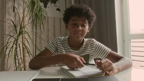 Focused Student Studying at Home With Laptop