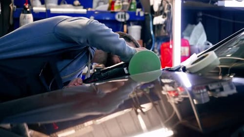 the Car Mechanic at a Service Station Doing the Final Polishing to Shine