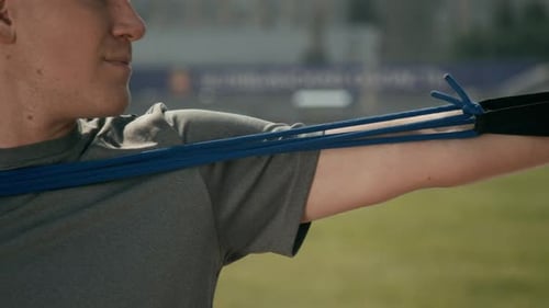 Young Adult Male Stretching With Resistance Bands