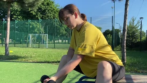 A Female Athlete Works Out at the Sport Area in the Morning