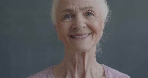 Slow Motion Portrait of Cheerful Senior Woman Smiling Looking at Camera with Happiness