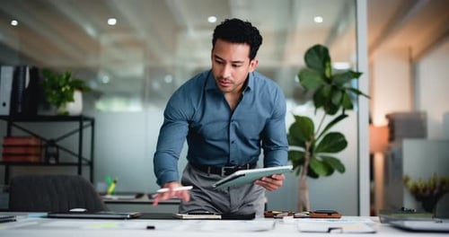 Man, tablet and writing with notes at office, documents or project report at investment company