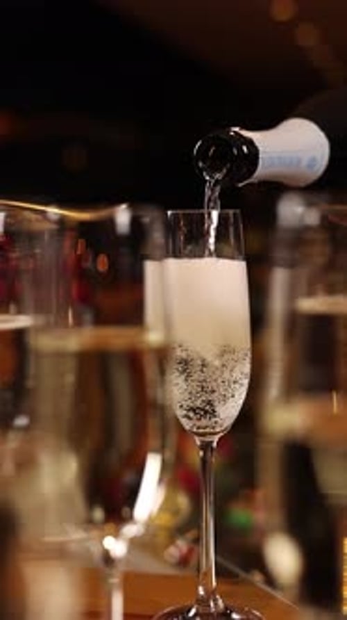 A bartender pours champagne. Close up