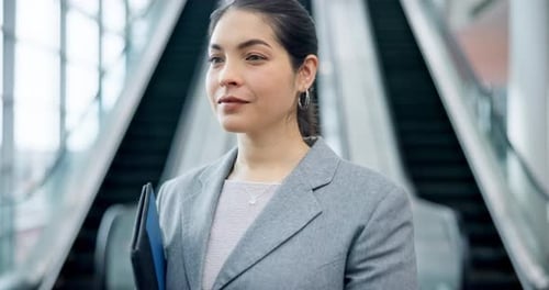 Smiling Young Professional Woman on Escalator