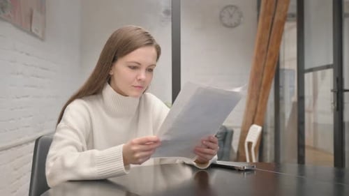 Woman Reads Documents and is Happy