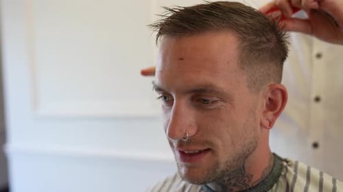 Young Man Getting Haircut at Barber Shop