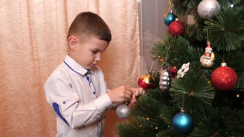 Child Decorating Christmas Tree with Baubles
