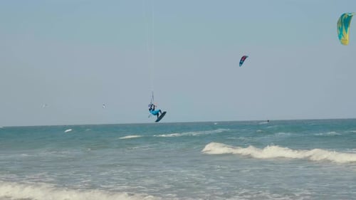 Kite Surfing or Windsurfing on Blue Sea Water