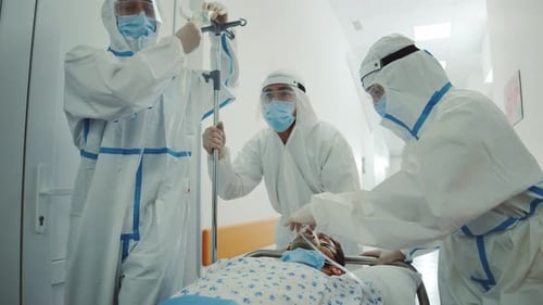 Medical Team with Patient on Stretcher in Hospital