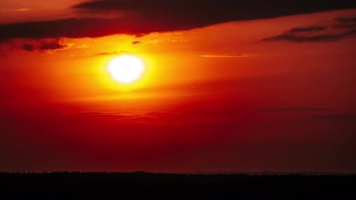Timelapse Dramatic Sunset with Sun Rays in the Sky Through Orange Layered Clouds