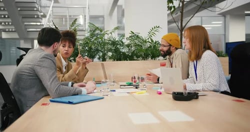 Diverse Professionals Engage in Communication in Office