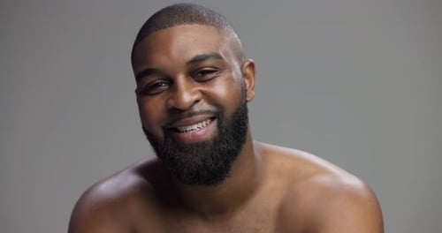 Skincare, black man and face with confidence in studio, hygiene and model with happiness