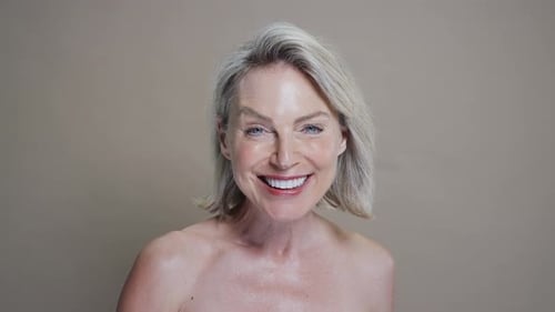 Attractive Woman with Short Blonde Hair Touching Face