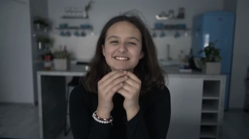 Teen Girl Laughing in Home Kitchen Setting