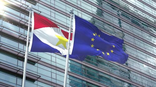 Saba and European Union Flags Waving Against Modern Building
