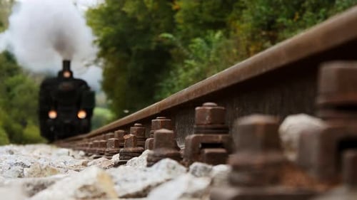 Approaching Steam Locomotive on a Rustic Railway Track Providing a CloseUp View