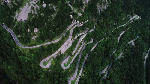 Spectacular Aerial View Of Winding Mountain Roads Through Dense Forest