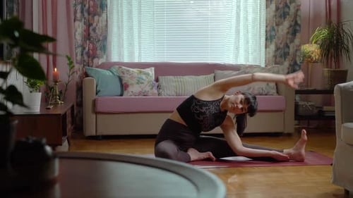 Woman Stretching on Yoga Mat Indoors