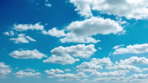 Blue Sky with White Clouds. Puffy Fluffy White Clouds Moving Fast. Cumulus Cloudscape Timelapse