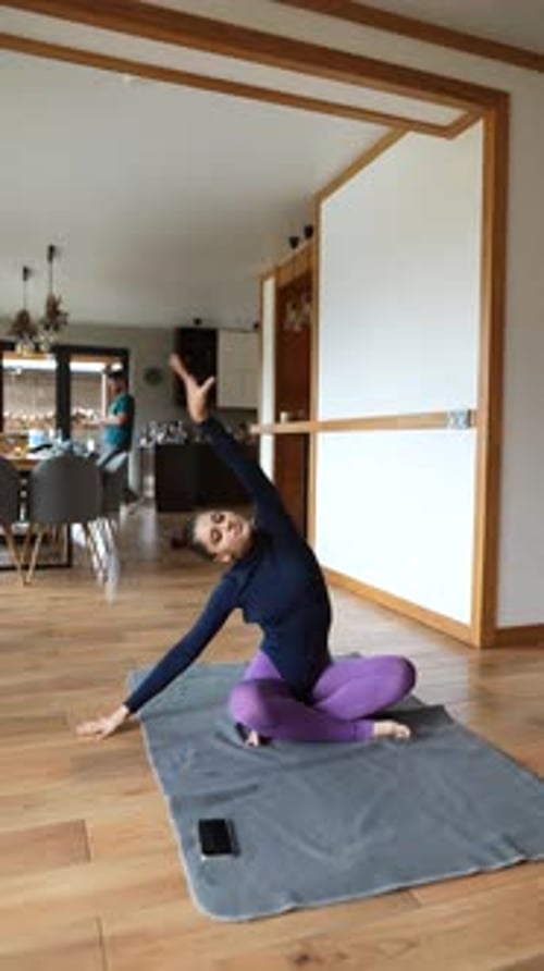 Woman Practicing Yoga and Stretching at Home