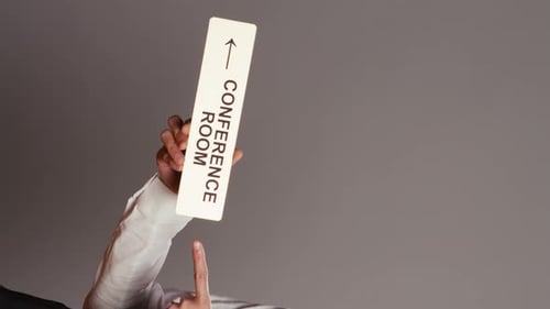 Hand Points to Conference Room Direction