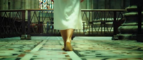 Godly woman in white burlap dress walking barefoot in church.