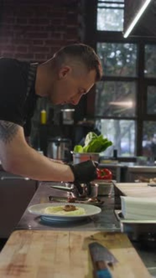 Chef Plating Dish in Restaurant Kitchen