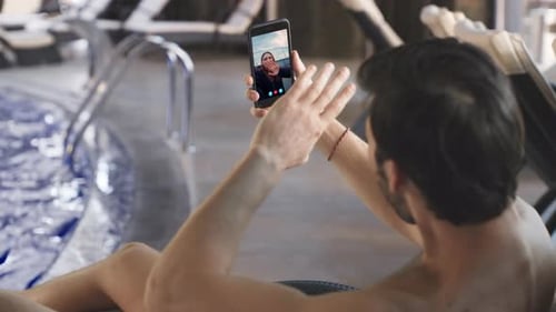 Pool Guy Video Calling Smartphone Closeup Smiling Girl Waving in Mobile Phone