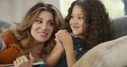 Mother and Daughter Relaxing Together on Couch