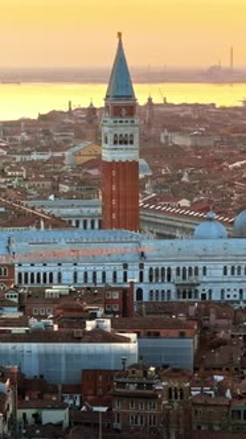 Aerial drone view of St. Mark's Square with Venice City, Italy in the background, on a sunny day. Ve