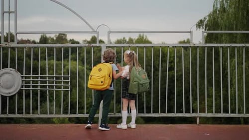 Curious First Graders Walking After Classes Cute Little Schoolboy And Schoolgirl Have Fun On Street