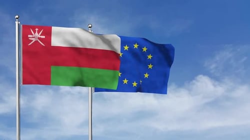 Flags of Oman and European Union Waving in Wind