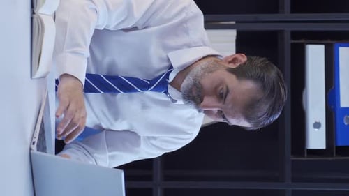 Man Excited at Desk Working on Laptop